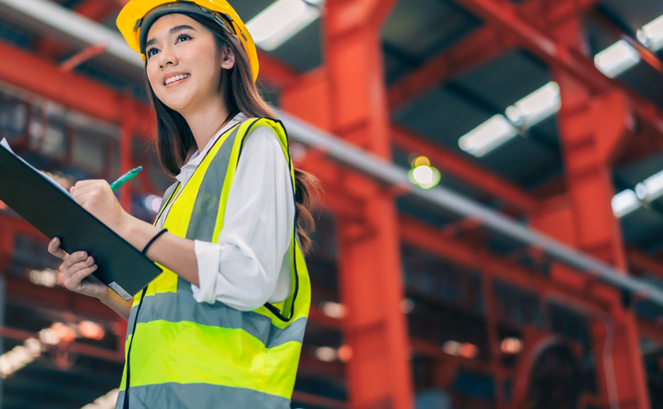Female worker taking notes in a factory