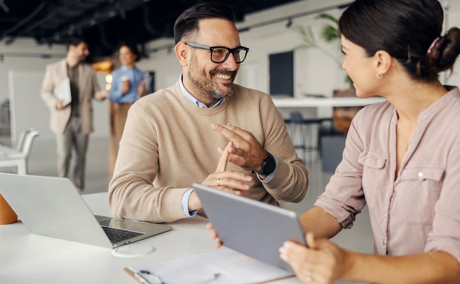 Colleagues conversing in an office