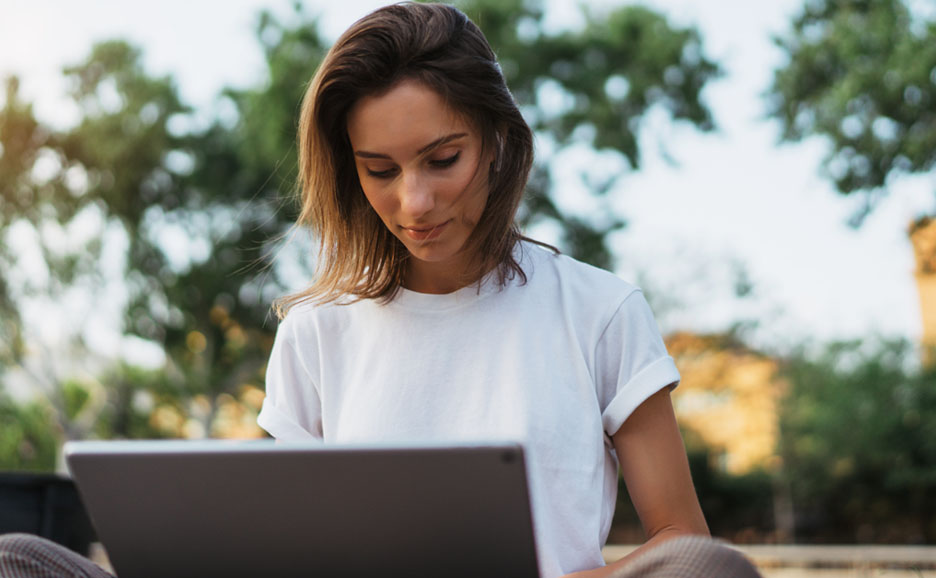 Woman working on a laptop outdoors